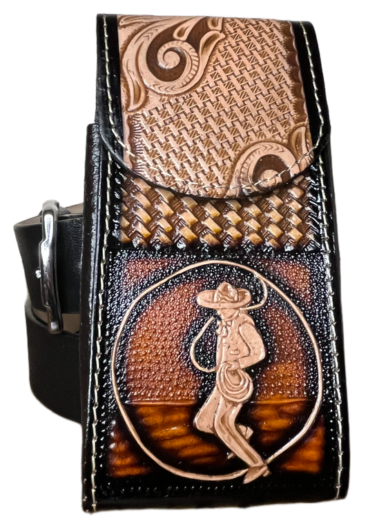 Decorative leather belt buckle with intricate designs on a black background