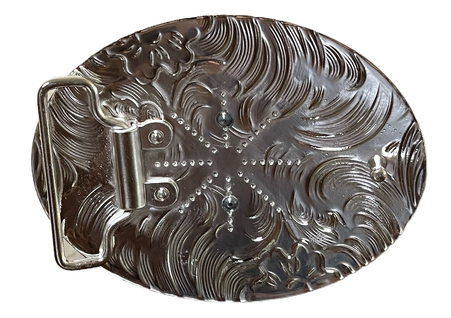 Decorative metal object with intricate patterns on a black background