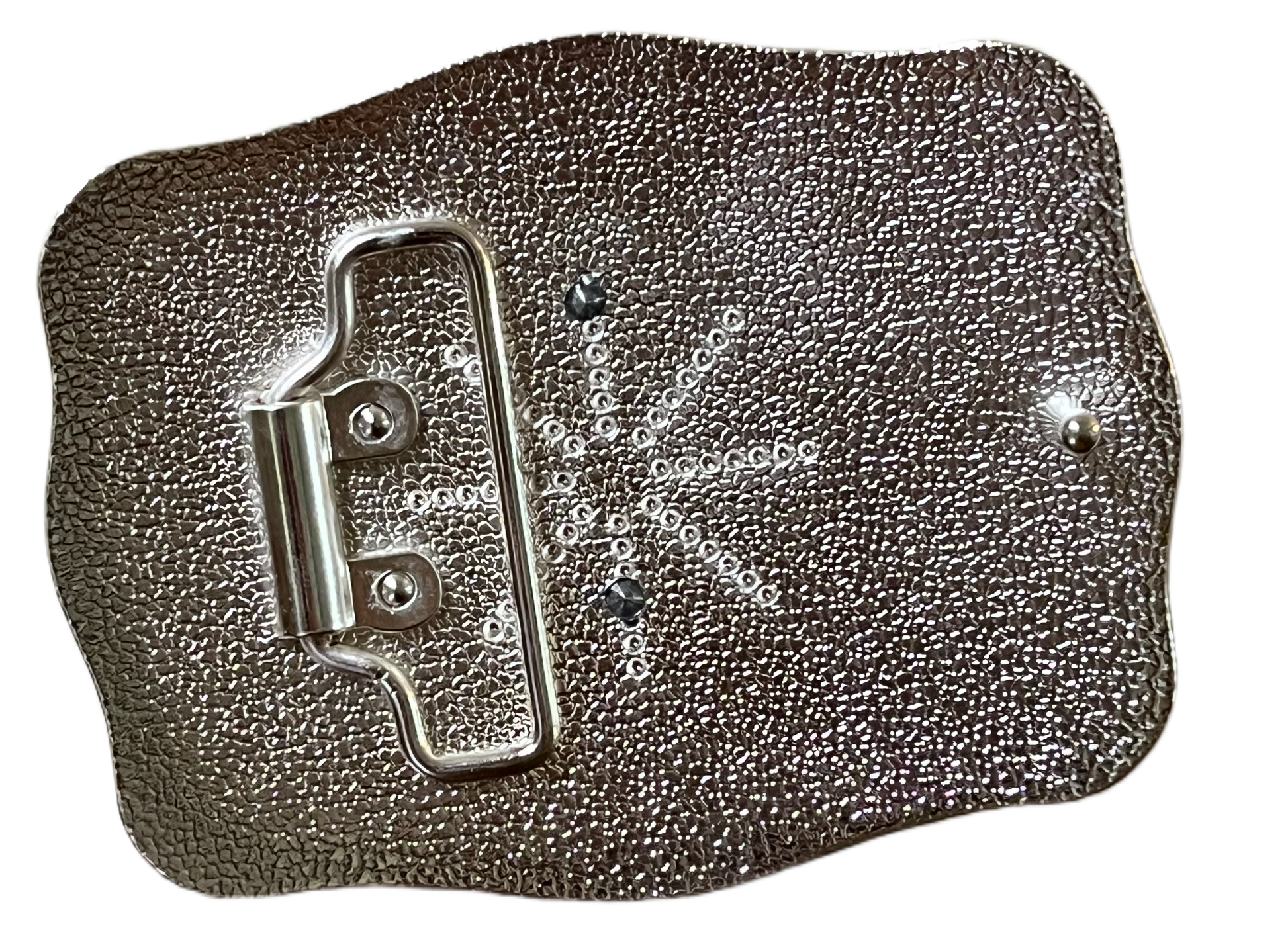 Metallic rectangular object with a textured surface on a black background