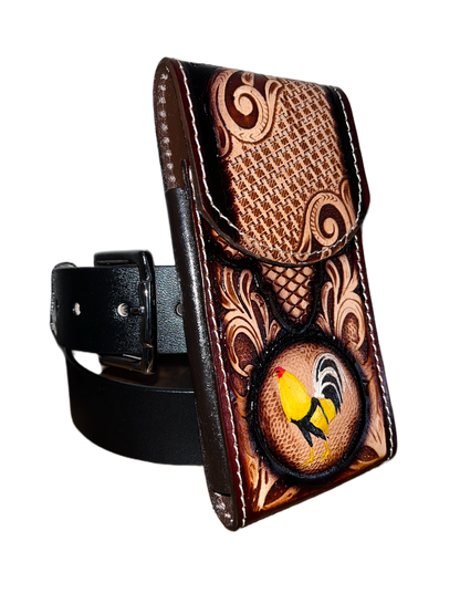 Decorative leather belt buckle with intricate patterns and a bird emblem on a black background