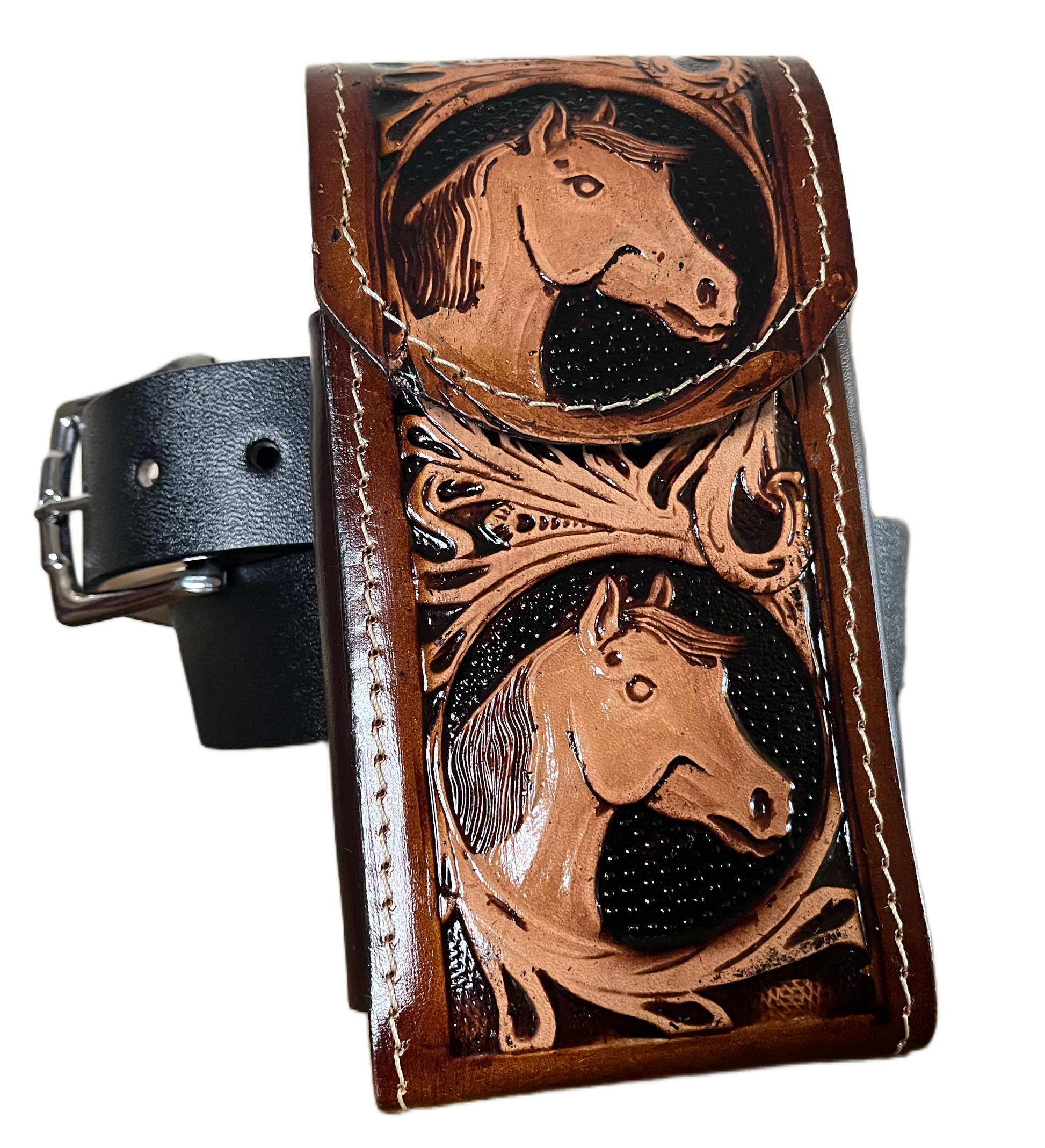 Brown leather wallet with embossed designs on a black background