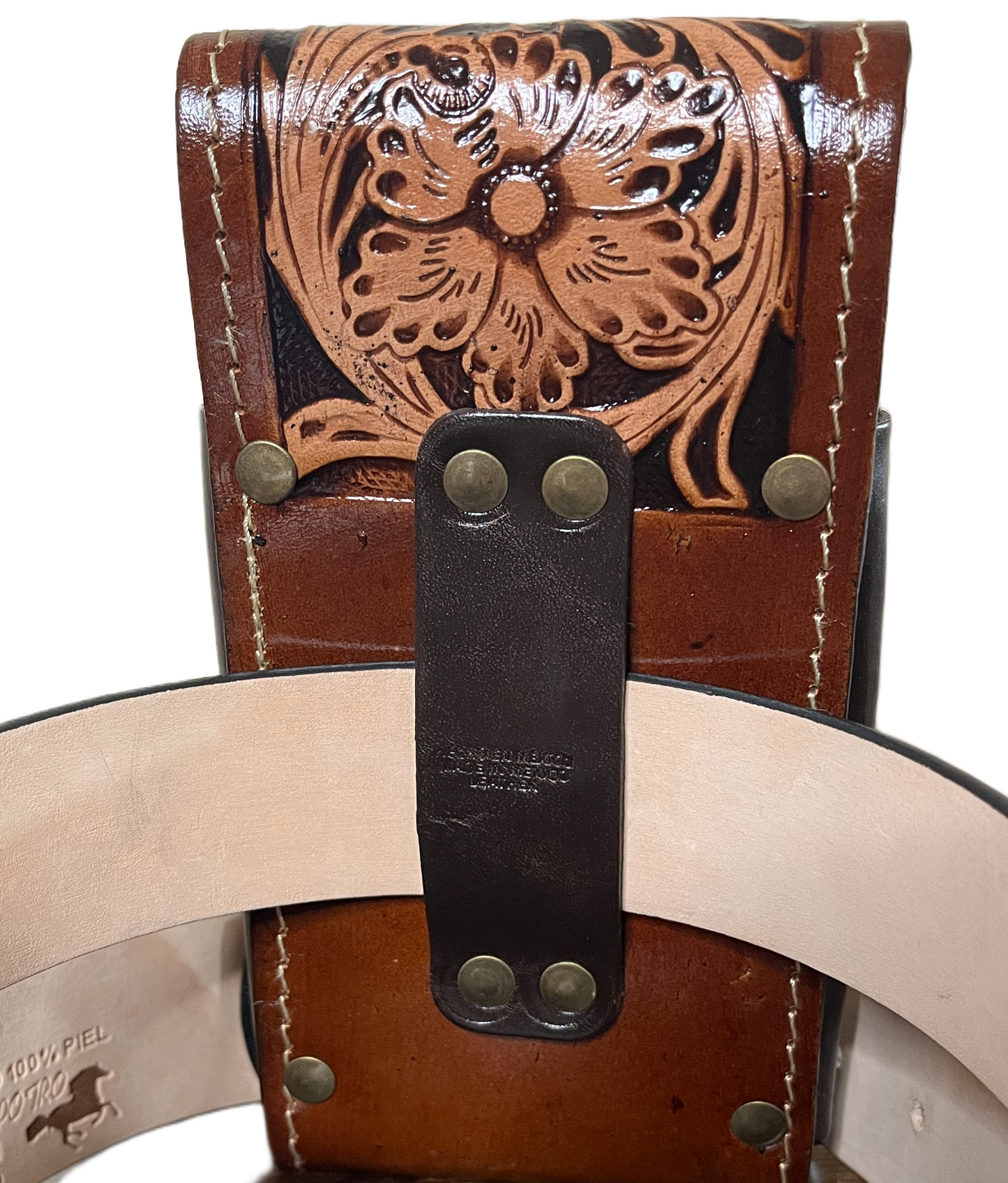 Close-up of a brown leather belt with intricate designs and metal buckles.