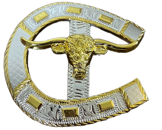 Decorative horseshoe with gold and silver longhorn design on a black background